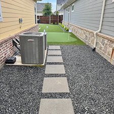 Backyard-Redesign-with-Artificial-Turf-Putting-Green-Landscape-Rock-Installation-in-McKinney-TX 2